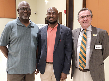 Associate professor Tarik Dickens with his father on left and engineering Dean Murray Gibson on right