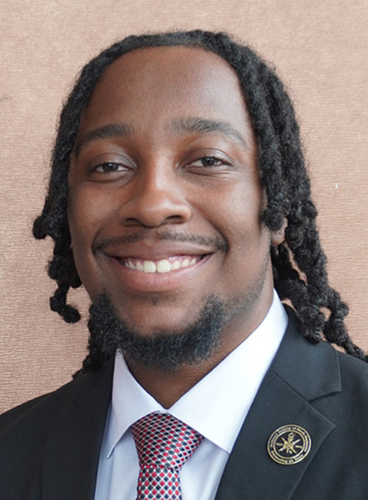 man with locs wearing a suit