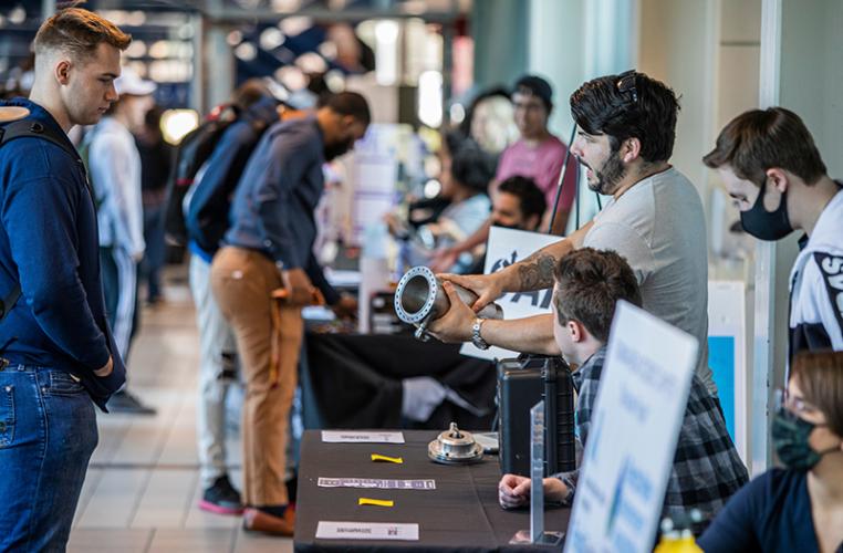 photo of engineering students talking about a prototype