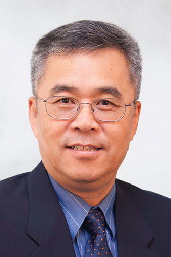 photo of man with short hair and glasses in blue suit and tie