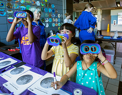 kids enjoy challenger learning center activities at the green and gold tailgate