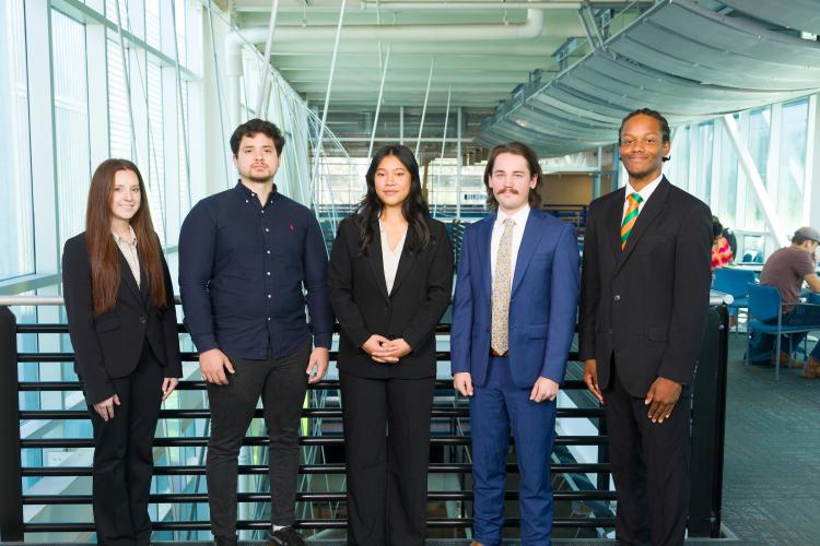 The five members of engineering senior design team 209 stand together on the third floor breezeway at the FAMU-FSU College of Engineering.