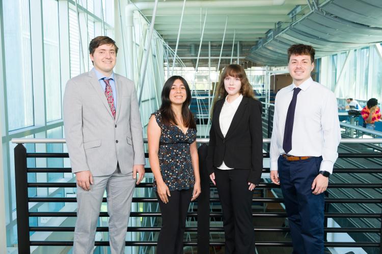 The four members of engineering senior design team 210 stand together on the third floor breezeway at the FAMU-FSU College of Engineering.