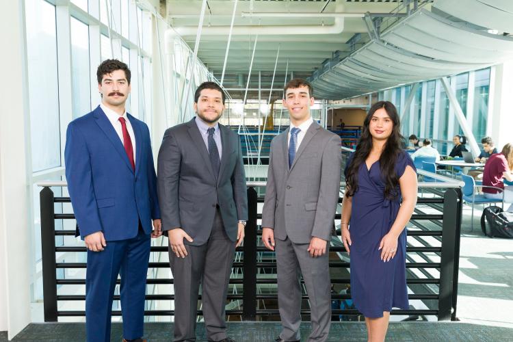 The four members of engineering senior design team 214 stand together on the third floor breezeway at the FAMU-FSU College of Engineering.
