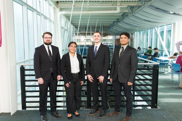 The four members of engineering senior design team 216 stand together on the third floor breezeway at the FAMU-FSU College of Engineering.