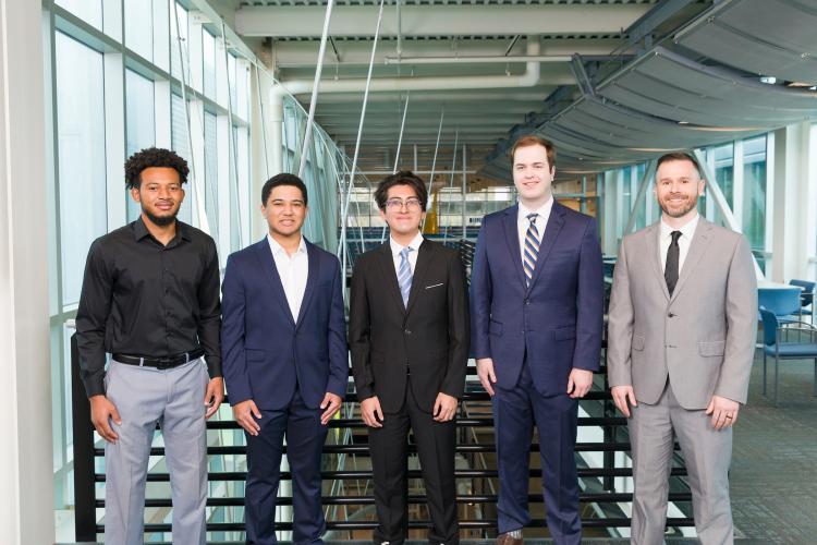 The five members of engineering senior design team 302 stand together on the third floor breezeway at the FAMU-FSU College of Engineering.