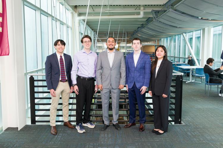The five members of engineering senior design team 303 stand together on the third floor breezeway at the FAMU-FSU College of Engineering.