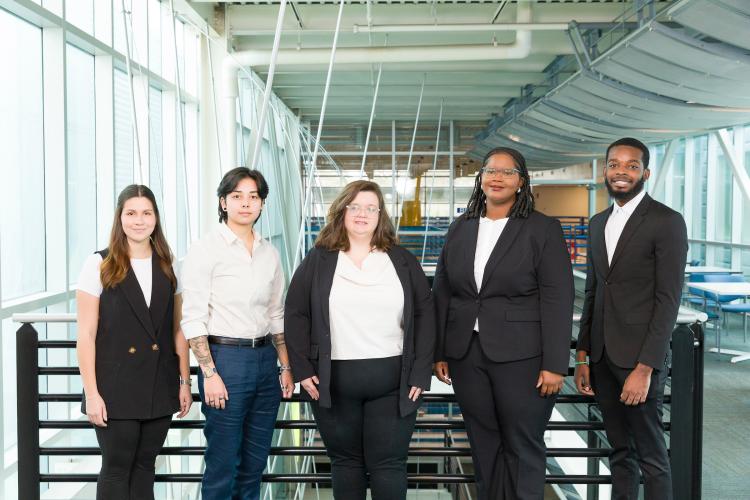 The five members of engineering senior design team 305 stand together on the third floor breezeway at the FAMU-FSU College of Engineering.
