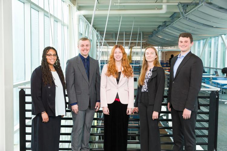 The five members of engineering senior design team 312 stand together on the third floor breezeway at the FAMU-FSU College of Engineering.