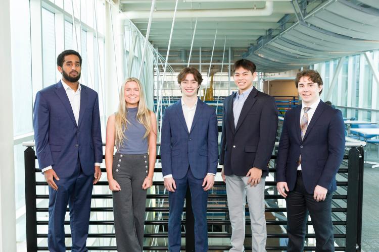 The five members of engineering senior design team 313 stand together on the third floor breezeway at the FAMU-FSU College of Engineering.