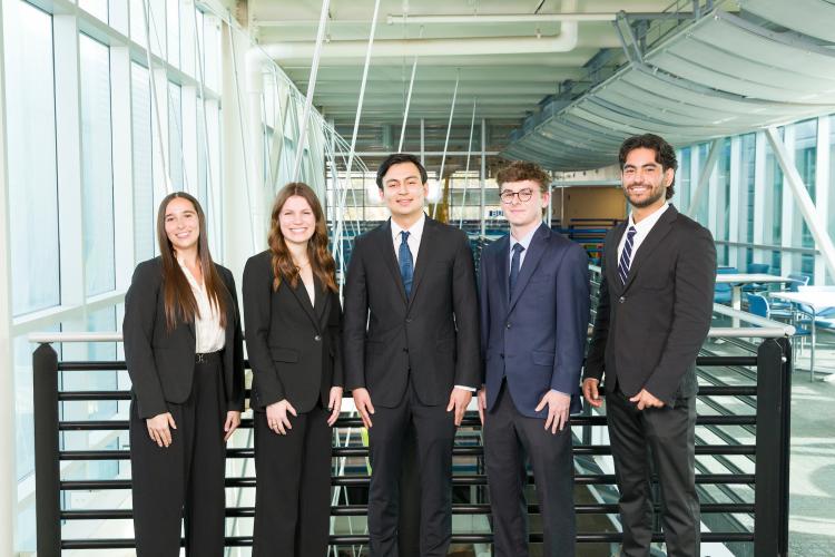 The five members of engineering senior design team 401 stand together on the third floor breezeway at the FAMU-FSU College of Engineering.
