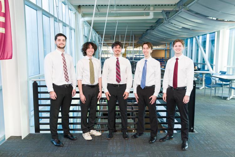 The five members of engineering senior design team 517 stand together on the third floor breezeway at the FAMU-FSU College of Engineering.