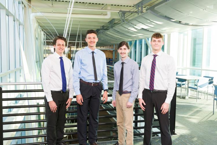 The four members of engineering senior design team 518 stand together on the third floor breezeway at the FAMU-FSU College of Engineering.