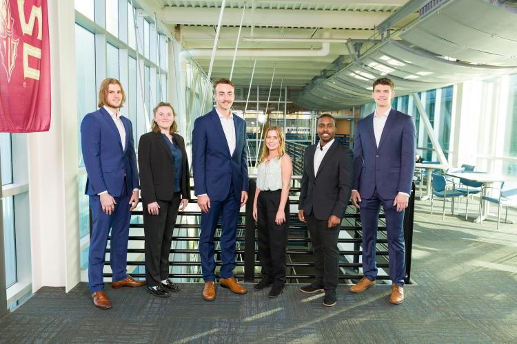 The six members of engineering senior design team 520 stand together on the third floor breezeway at the FAMU-FSU College of Engineering.