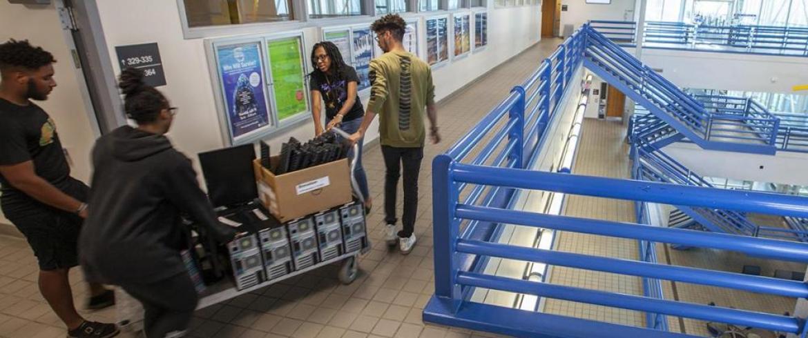 NSBE students wheel computers out of engineering college