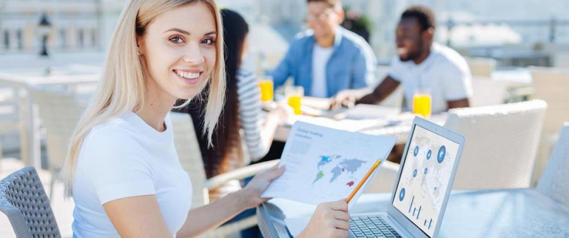 photo of girl and laptop holding a world map