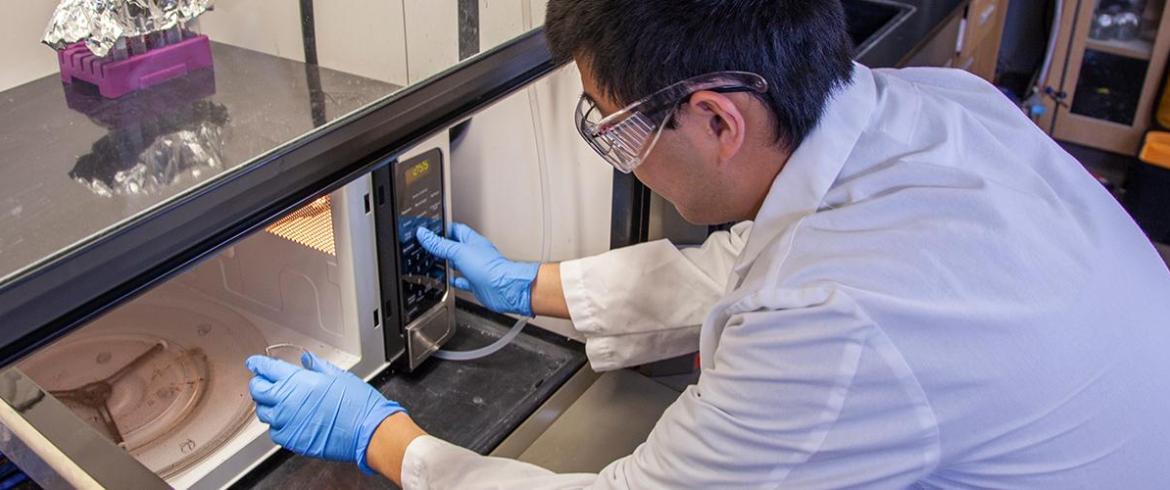 Dr. Gang Chen microwaves some biosolids, separating the organic material from the toxic metals.