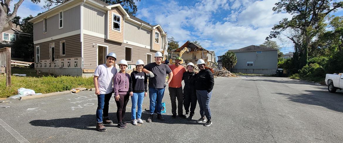 photo of engineering students and faculty in front of demolition site