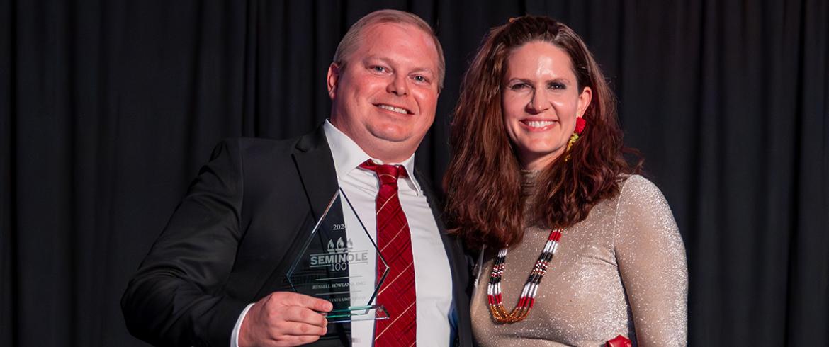 photo of famu-fsu engineering and florida state university alum adam russel accepting the seminole 100 award from marla vickers