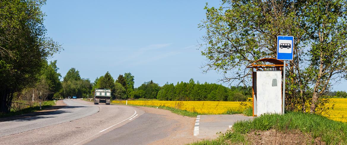 photo of empty bus stop on rural road