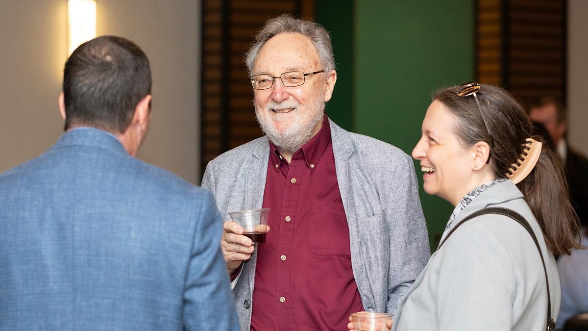 photo of people talking with drinks in hand