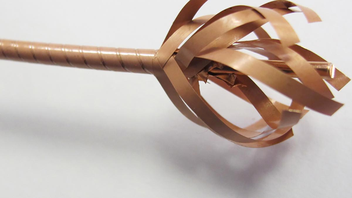 closeup photo of partially unwrapped brown wire with many layers weaved