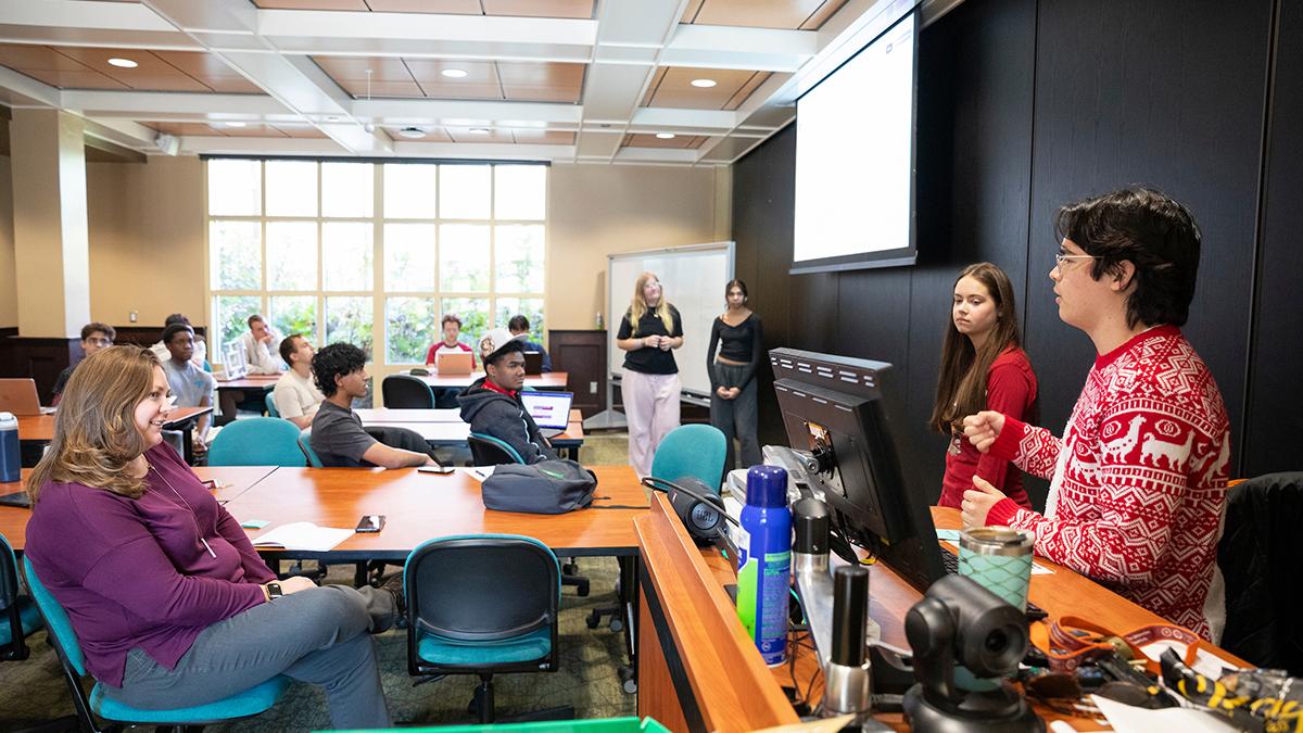 photo of students presenting in front of a class in college