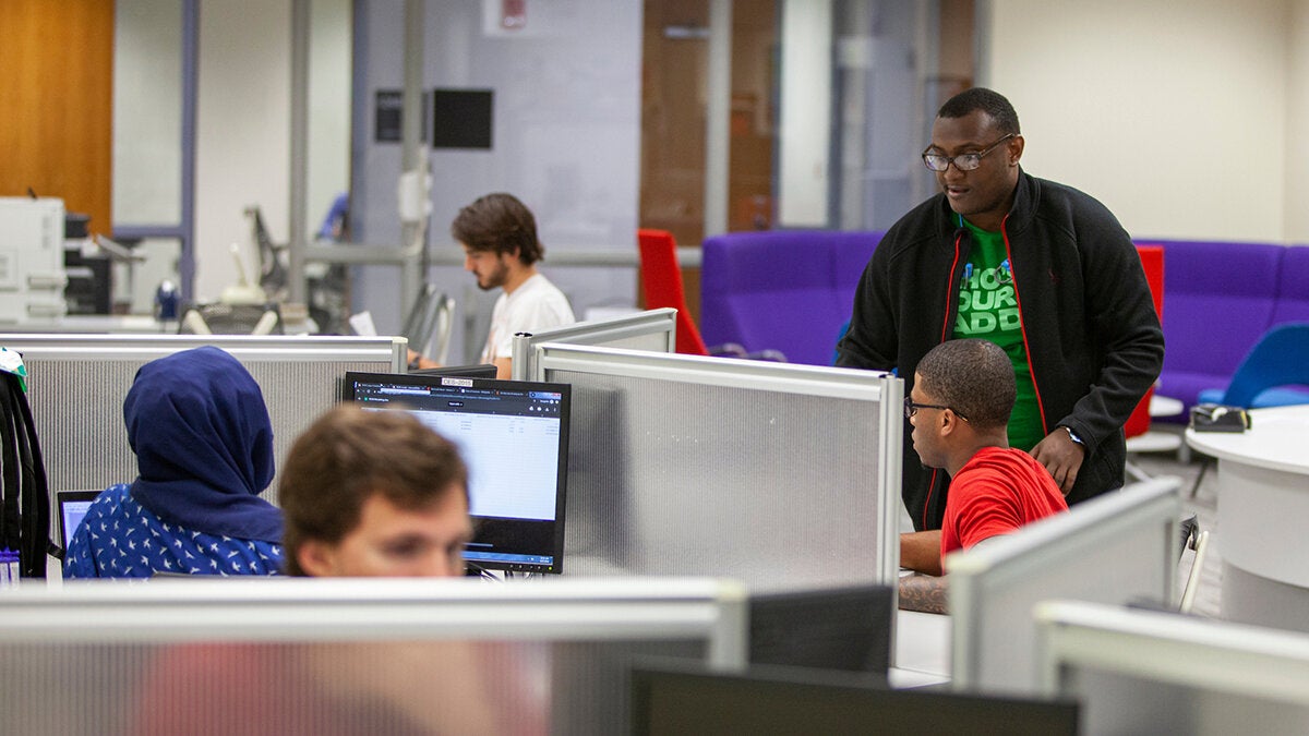 students in library sitting at carels