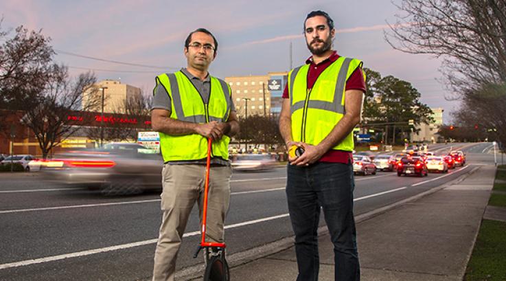 A professor and graduate student standing in front of TMH