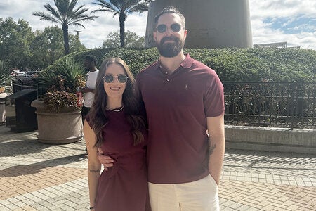 photo of couple wearing sunglasses outside embracing
