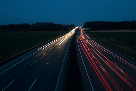photo of car lights on highway at night blurred