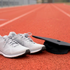 photo of athletic shoes and grad cap on track
