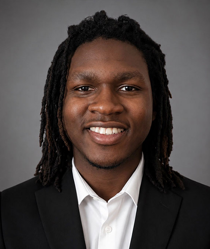 man with braids smiling in white shirt and black jacket