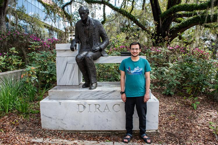 photo of engineering undergrad aashutosh pokharel at the paul dirac statue on fsu campus
