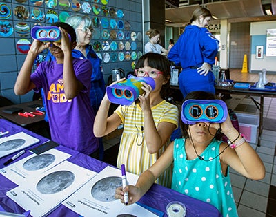 kids enjoy challenger learning center activities at the green and gold tailgate